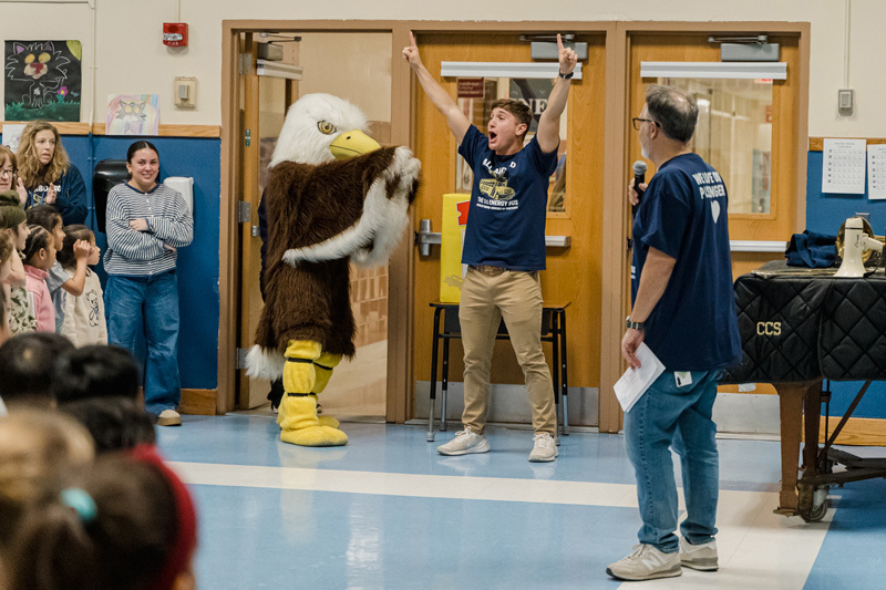 students and mascot in gym