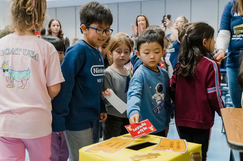 students put paper in a box with a hole in it