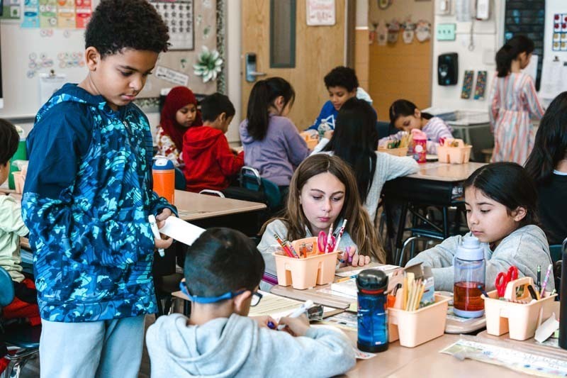 Students coloring with markers.