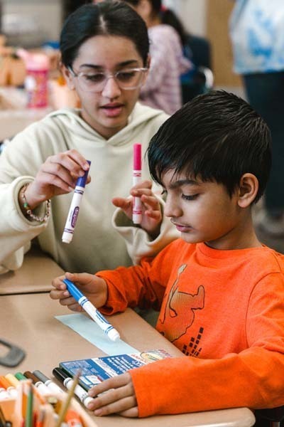Students coloring with markers.