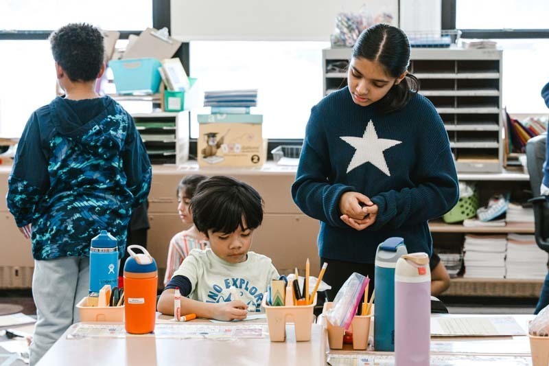 Students coloring with markers.