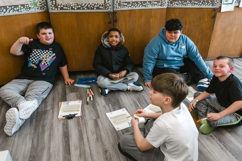 Students coloring with markers.