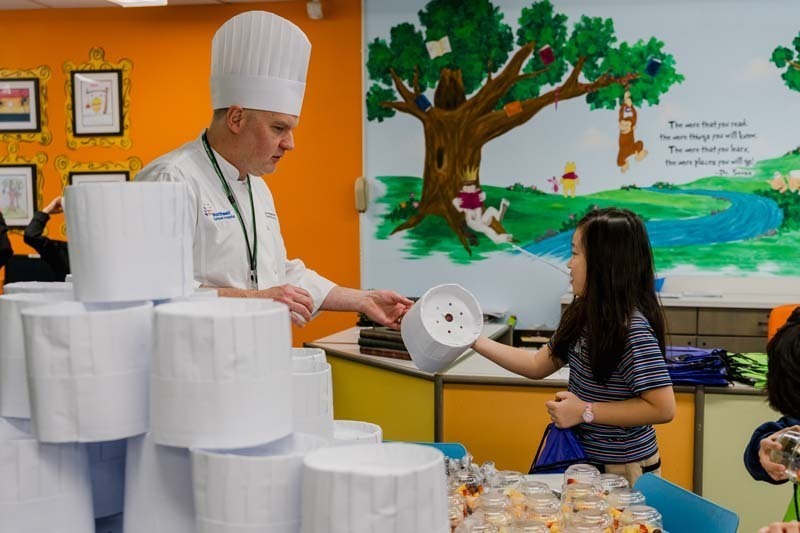 Student speaking with chef.