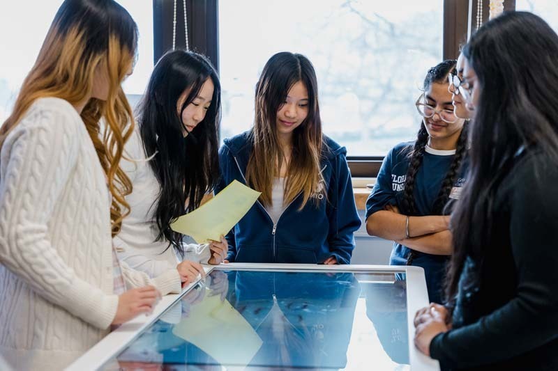 Students looking at large screen.