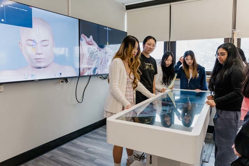 Students looking at large screen.