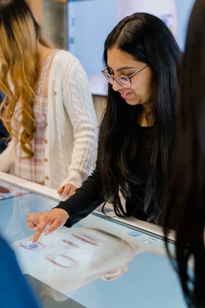 Students looking at large screen.