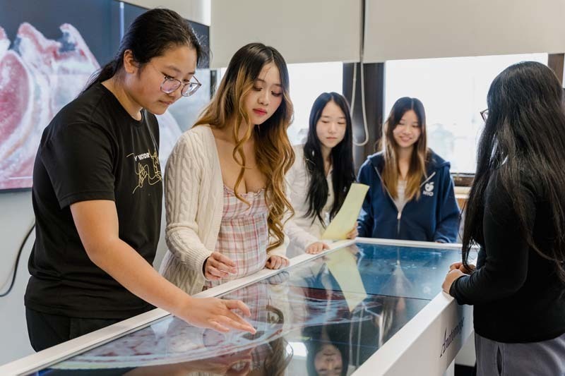 Students looking at large screen.