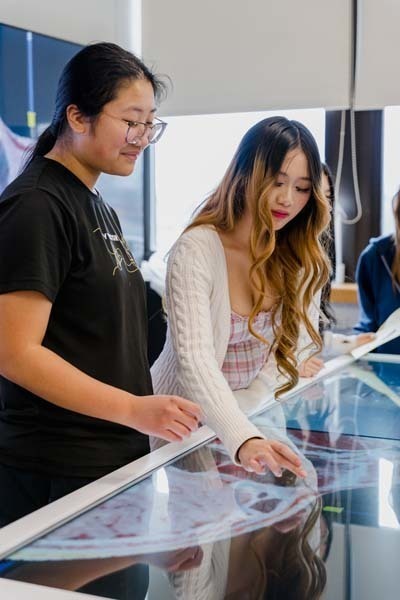 Students looking at large screen.