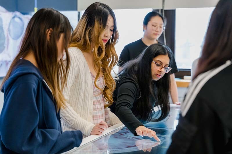 Students looking at large screen.