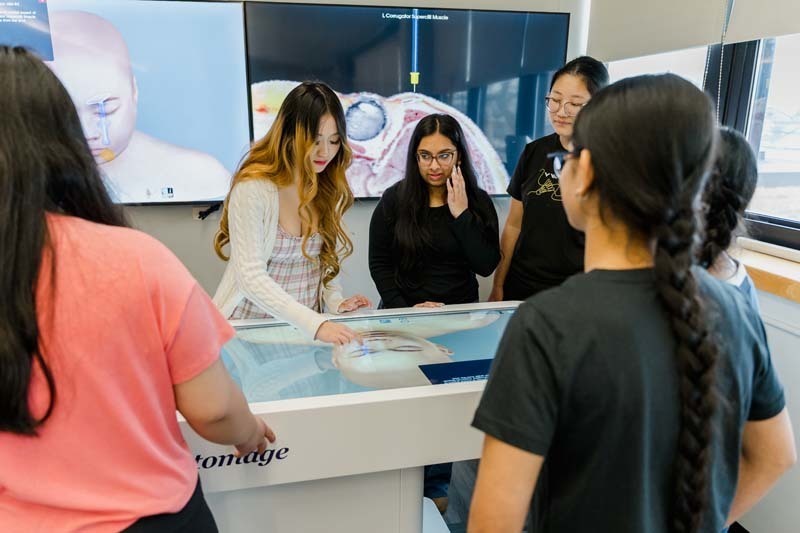 Students looking at large screen.