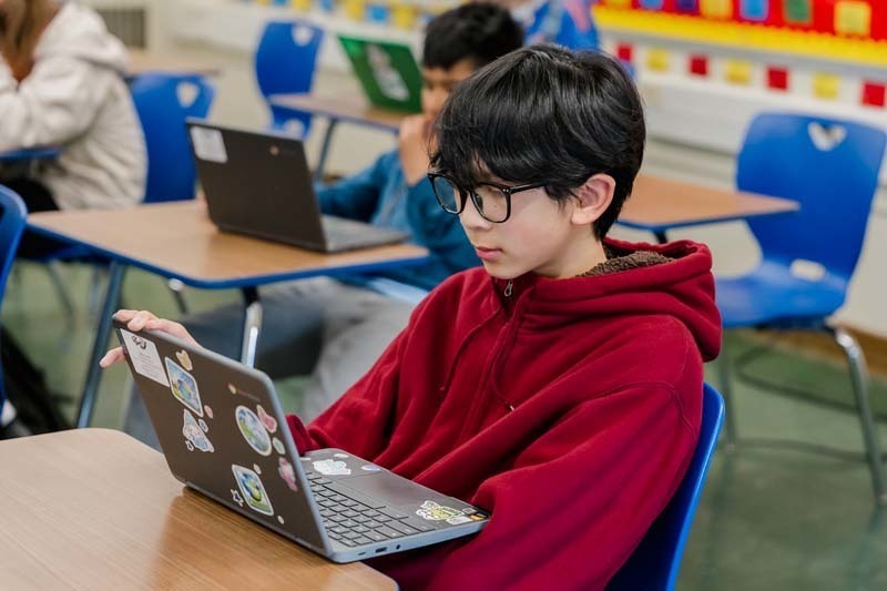 Student working on laptop.