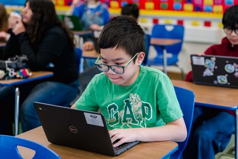 Student working on laptop.