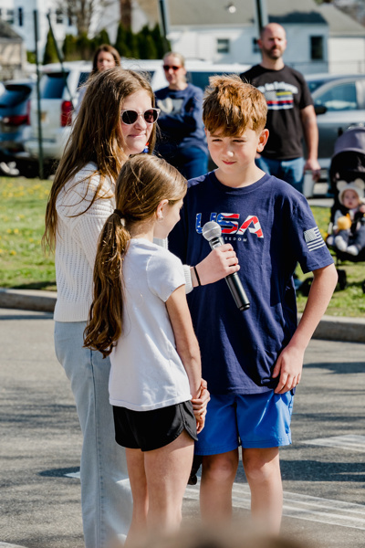 Community event at Central Boulevard Elementary with children and firefighters enjoying a meal together, fostering relationships and celebration.