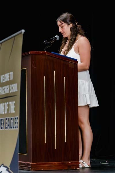 Student speaking into podium.