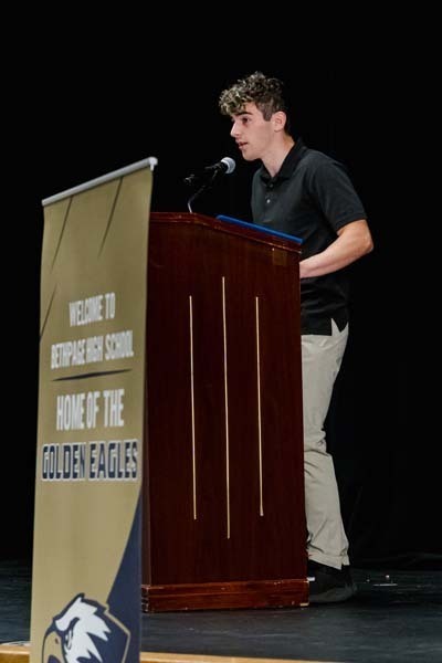 Student speaking into podium.