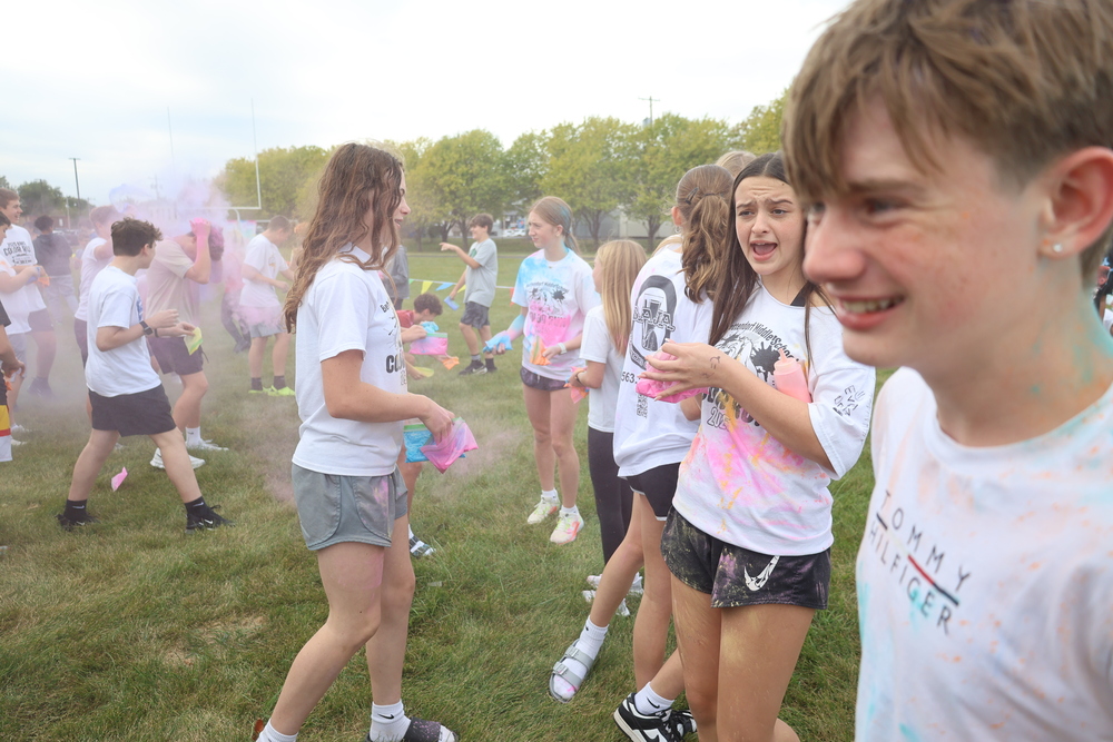 BMS 2025 color run - students with white shirts are being dusted with color