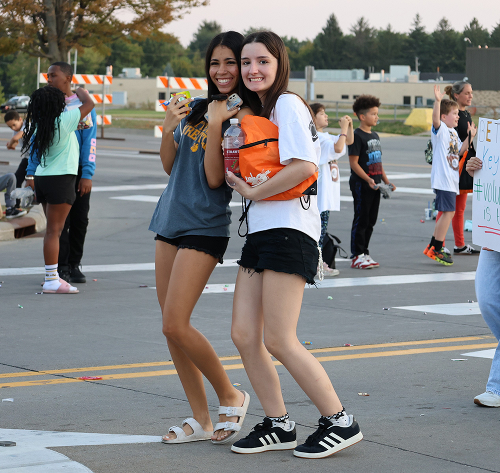 Two girls in the parade stop and pose for the camera