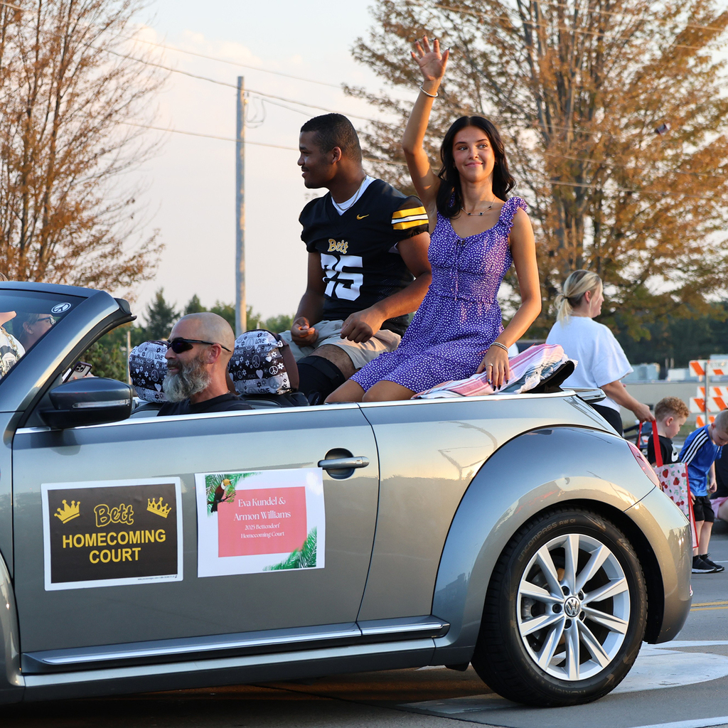 Homecoming court couple in a car