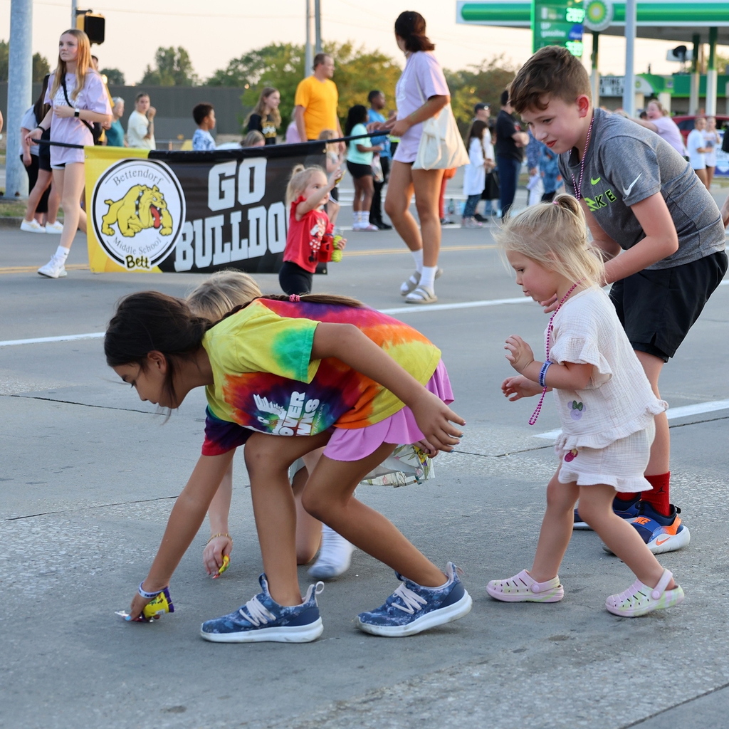 Kids picking up candy from the road