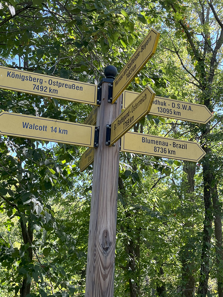 Road  sign with km to Walcott, Brazil, and other international locations