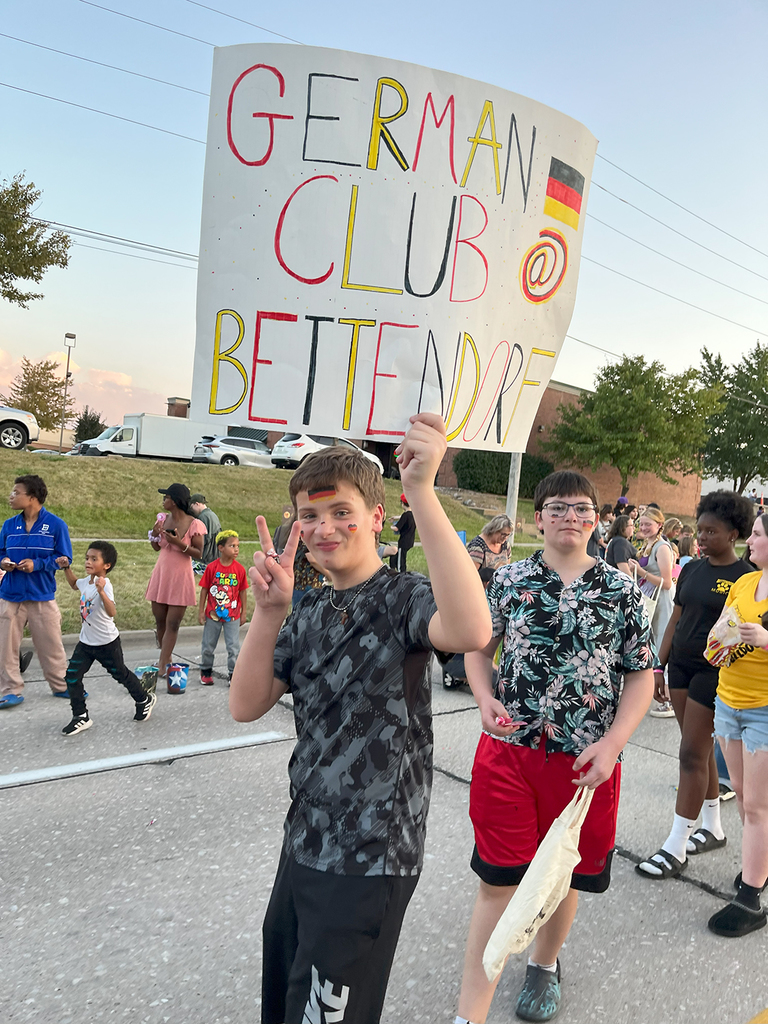 German club student holding up sign in homecoming parade