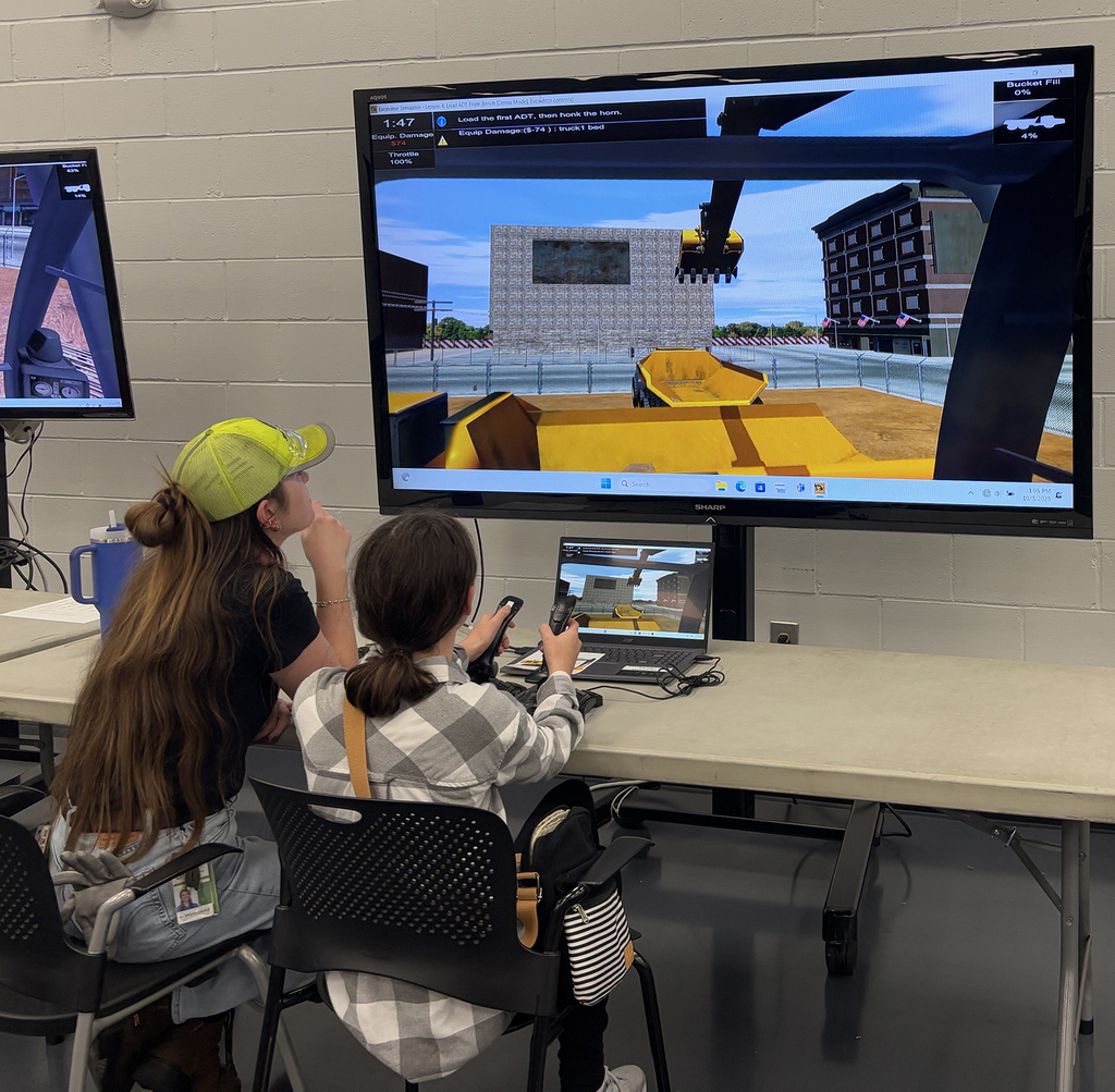 Two girls operating a crane - online