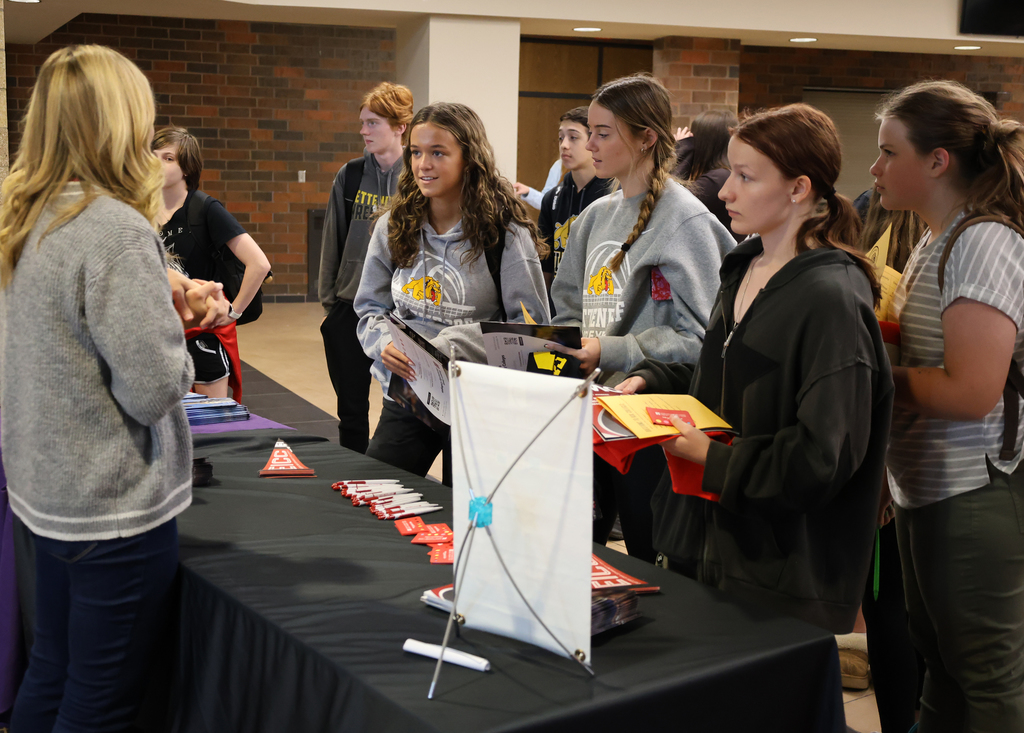 Students visit with a college rep