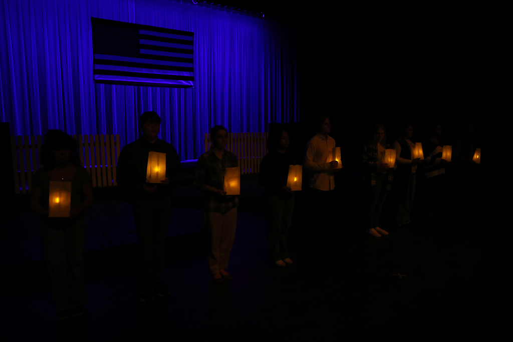 Dark stage with luminaries and American flag