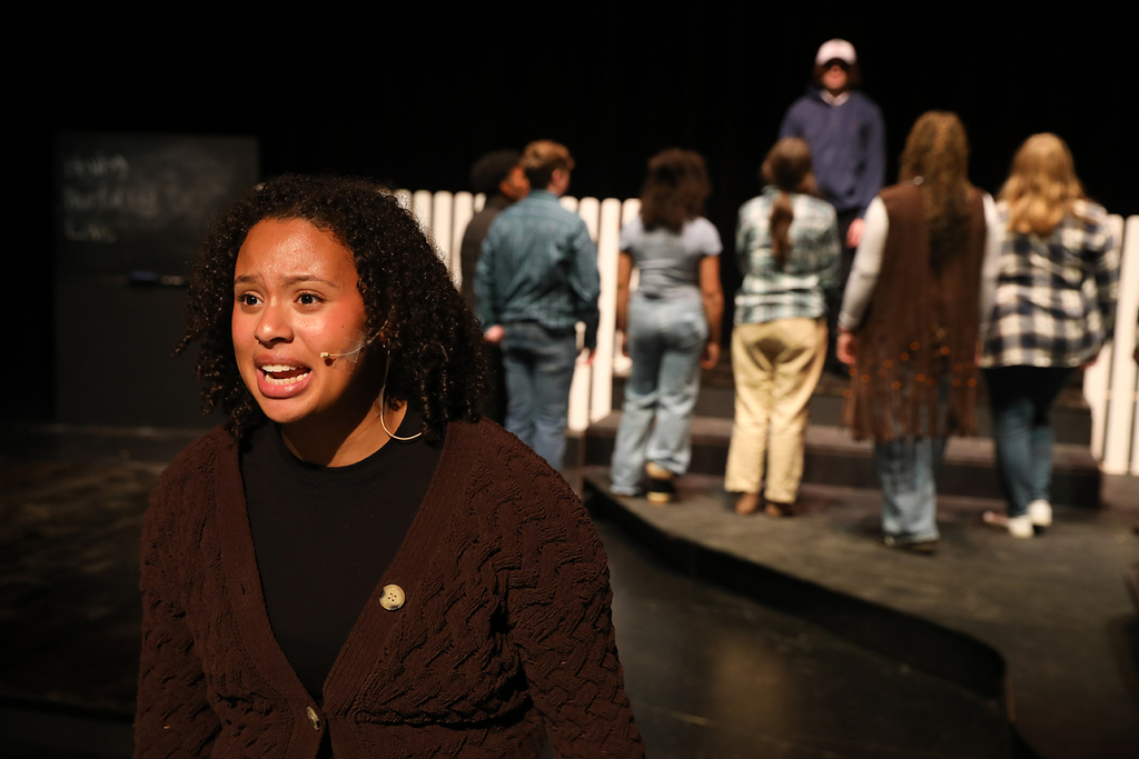 Student with community facing away from student