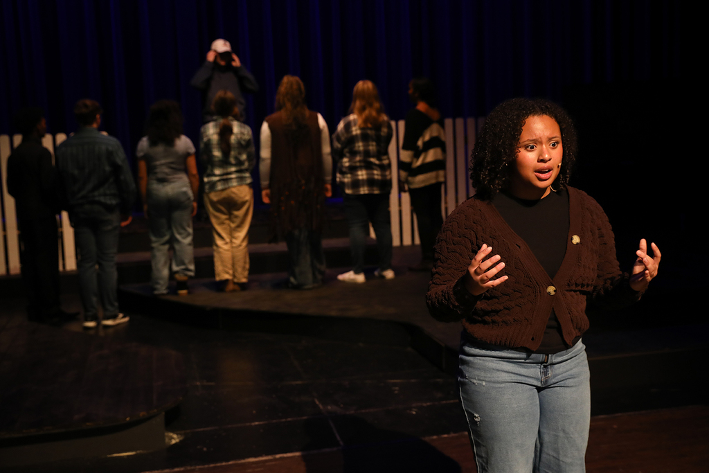 Student with community facing away in the background