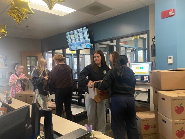 Students passing on boxes to load up