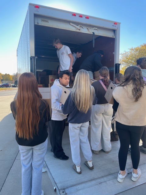 Students loading boxes on a truck