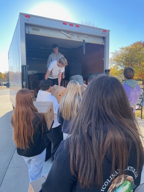 Students loadin boxes on a truck