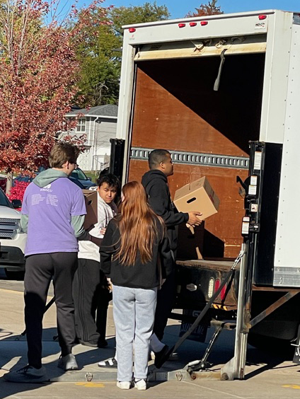 Students loading boxes on a truck