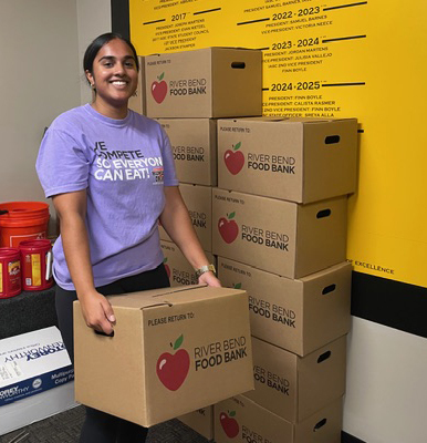 Student holding box of donations