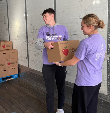 Students loading box on the truck