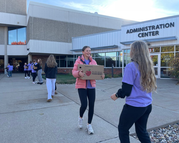 Students moving boxes in a fireman line