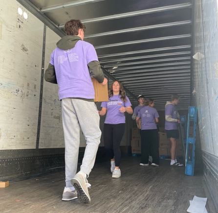 Students loading boxes on the truck