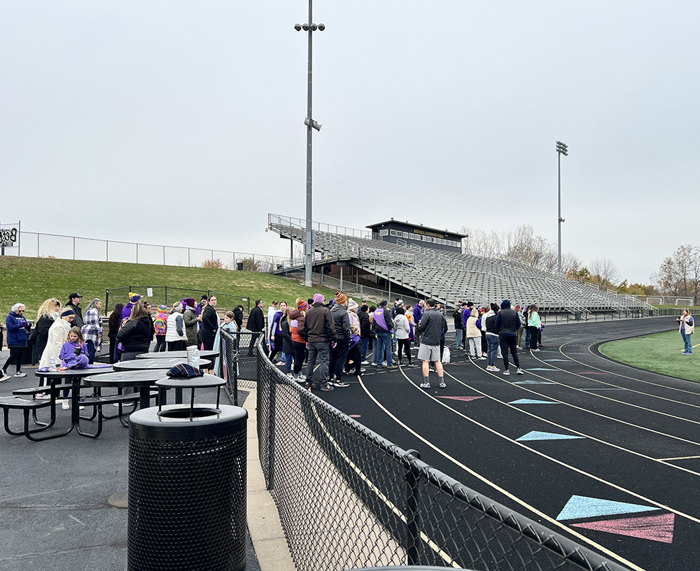 Walkers listening to a speaker kicking off the event