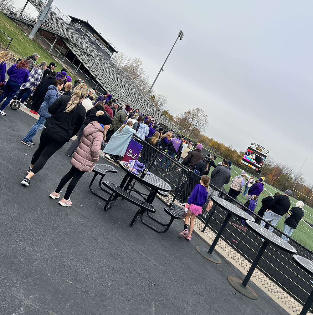 Walkers listening to a speaker kick off the event