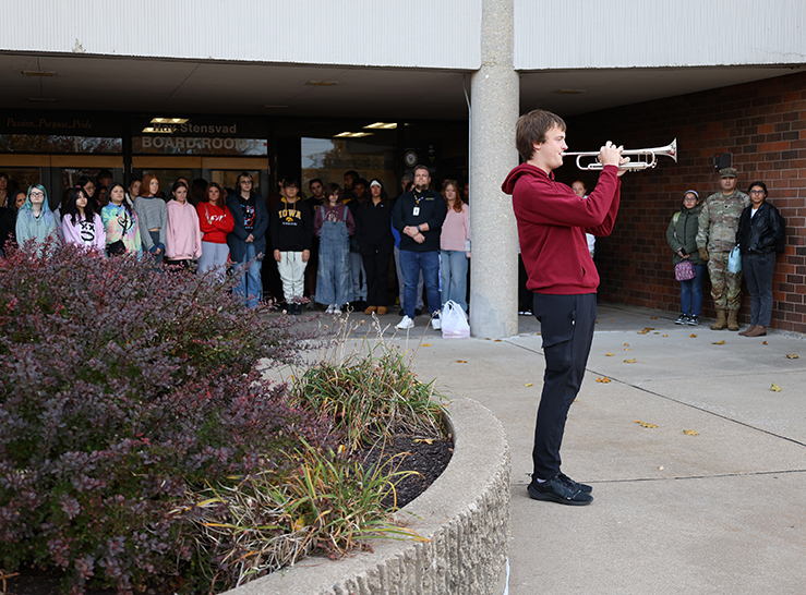 Student plays Taps on trumpet at HS Veterans Day Ceremony