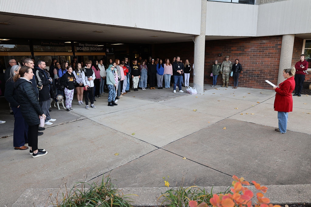 Social Studies Teacher Jamie Schanz and crowd at HS Veterans Day Ceremony