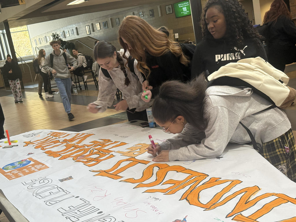 HS students signing a pledge to be kind.