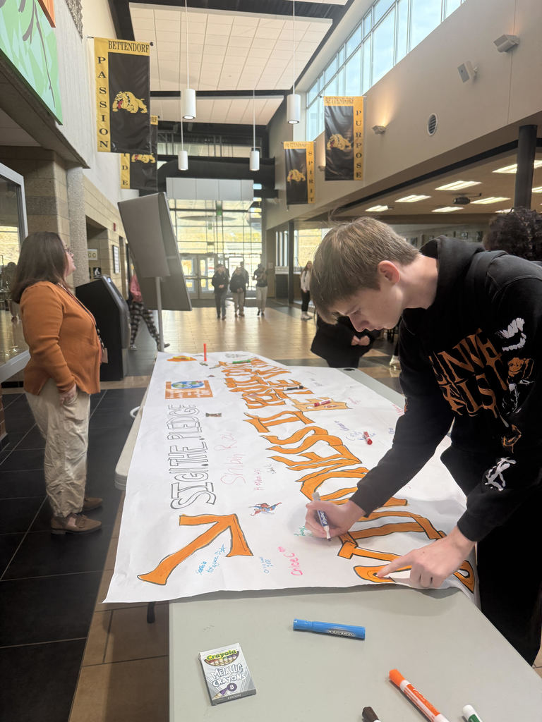 HS student signing a pledge to be kind.