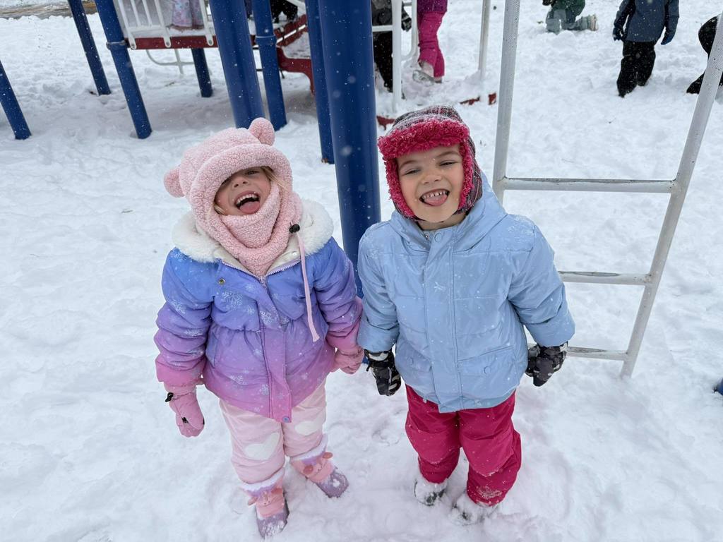 Two students waiting for snow flakes to land on their tongue