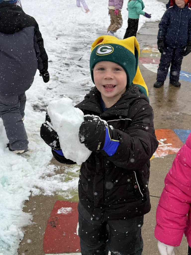 Boy showing off a chunk of snow