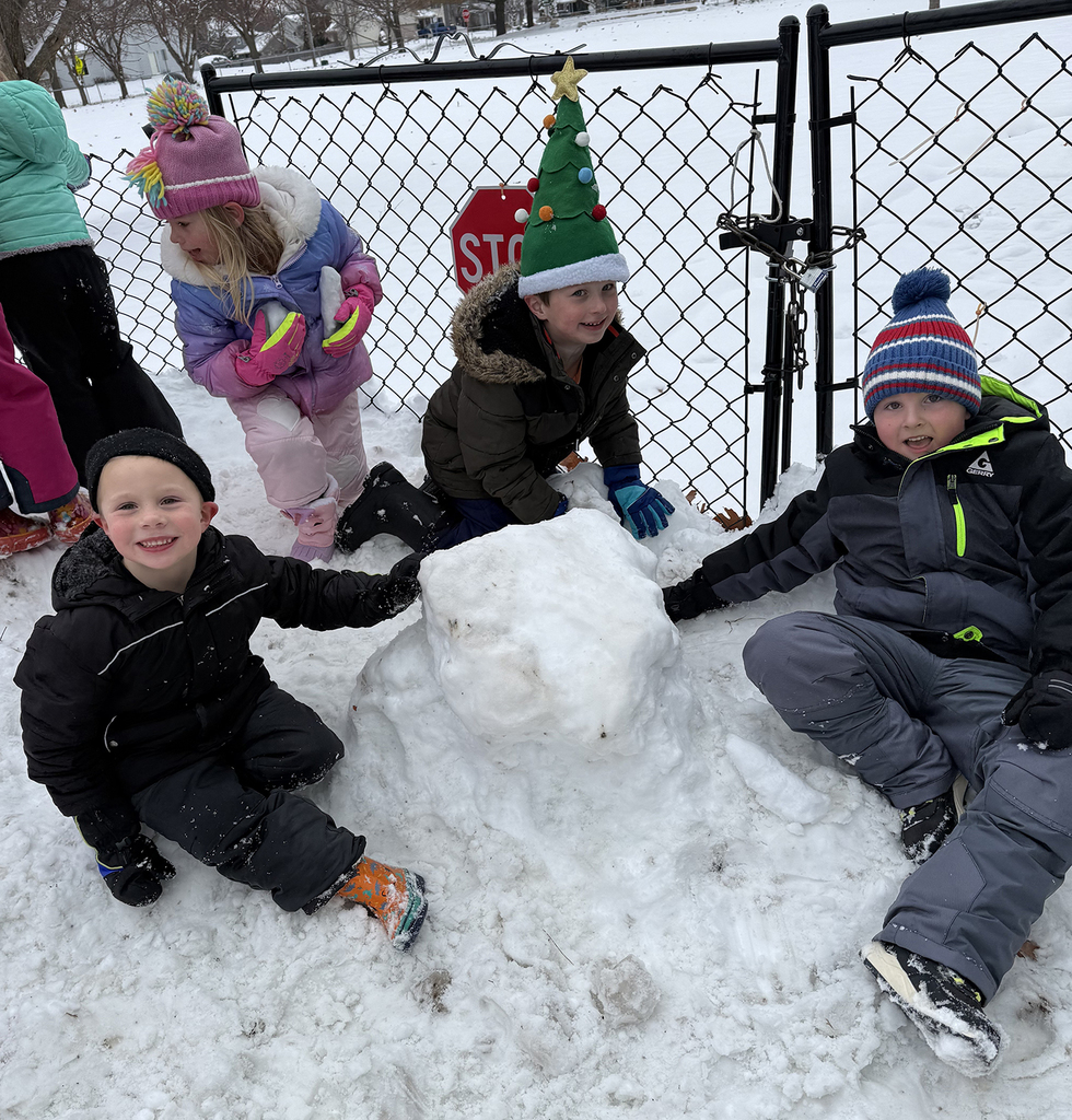 Three boys building a snow man
