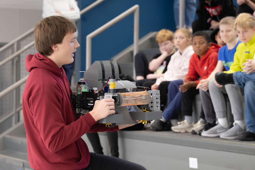 Noah Leavitt demonstrates the team's robot