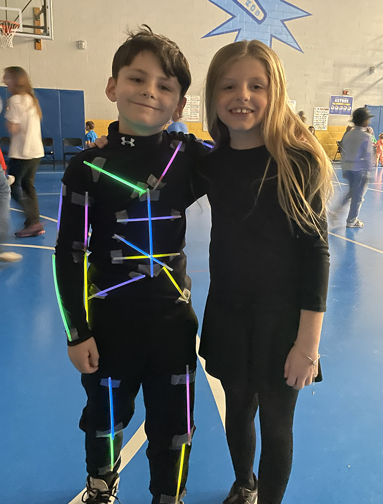 Dance Marathon - Student with glow stick outfit with another student