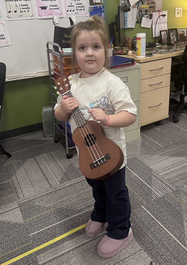 Student in music room with ukulele
